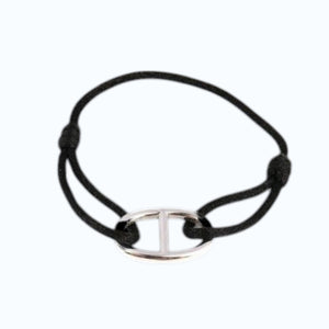 The STOLEN RICHES Viseu String Bracelet features an anchor chain fixture in black, shown on a light background.