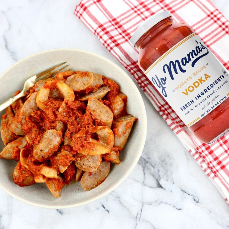 A jar of YO MAMA'S VODKA SAUCE by YO MAMA'S FOODS. The label indicates it's made with fresh ingredients, is all-natural, KETO certified, contains no sugar, and is gluten-free. Handmade in small batches, the jar has a net weight of 25 oz (708g).