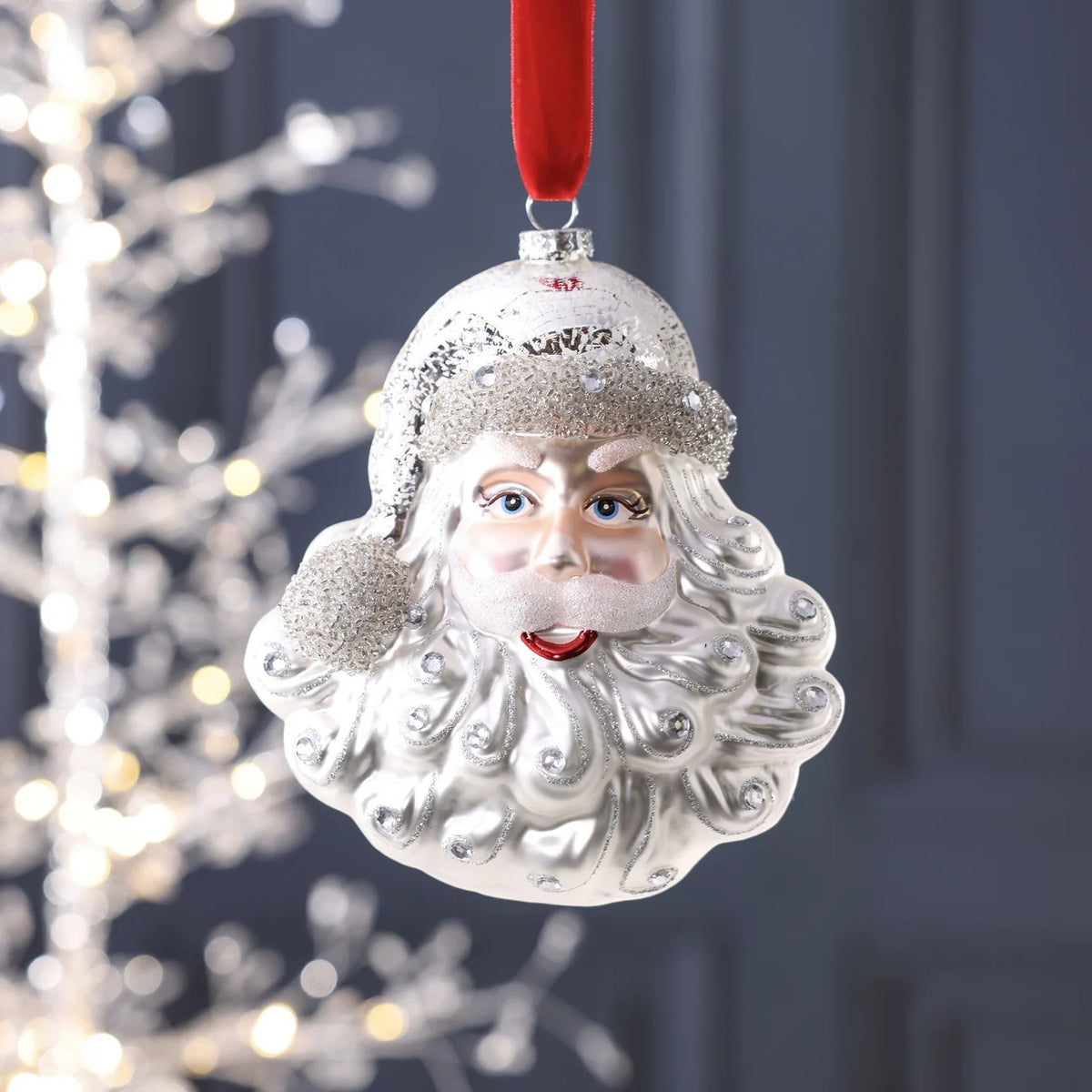 ZODAX SANTA CLAUS GLASS ORNAMENT measuring 4.75 x 3 inches, featuring a glass Santa Claus face decorated with glittery accents.