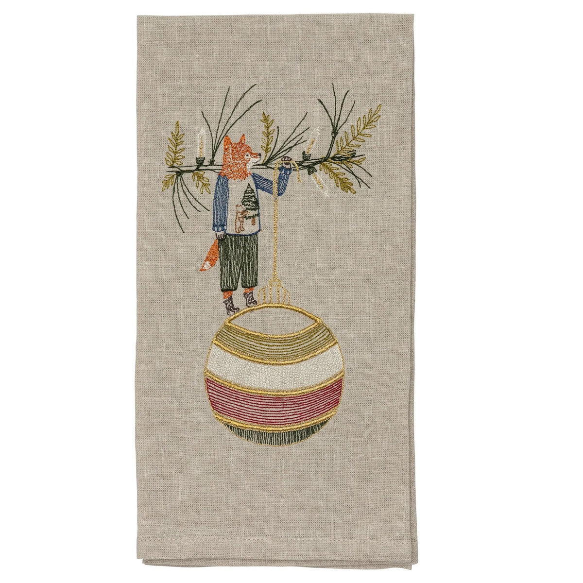 A beige linen DECK THE HALLS FOX LINEN TEA TOWEL embroidered with a fox holding a large, striped Christmas ornament, perfect for vintage Christmas kitchen decor.