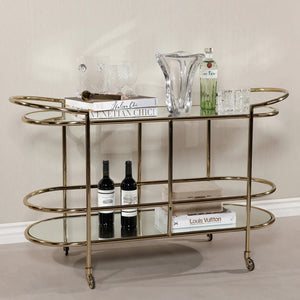 The ZODAX CONSOLE BAR CART showcases a minimalistic design with a shiny gold metal frame, mirrored shelves, curved corners, and clean lines—making it a stylish serving station for any modern space.