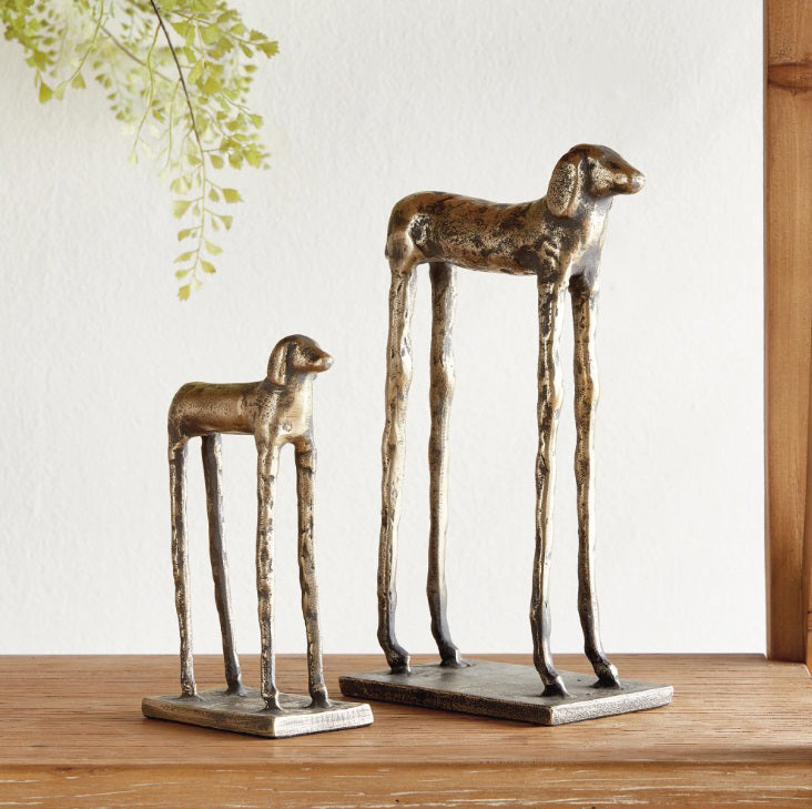 The NAPA HOME AND GARDEN Hound Dog Sculptures feature elongated legs and a textured antique finish on rectangular bases—perfect desk decor or a distinctive bookshelf accent from NAPA HOME AND GARDEN.