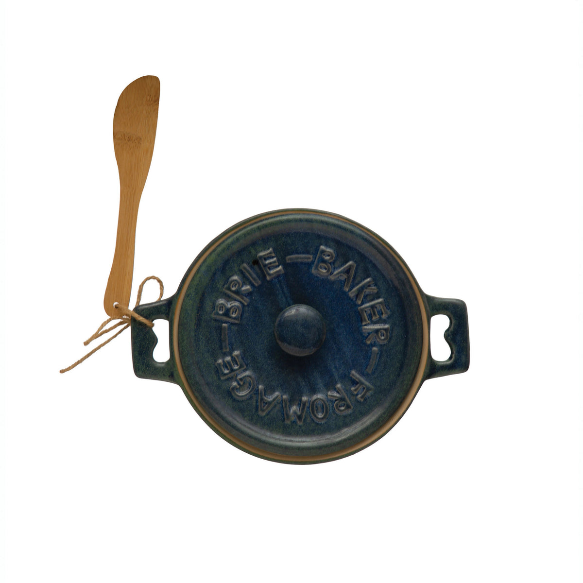 Top view of the CREATIVE COOP BRIE BAKER WITH BAMBOO SPREADER, a round blue stoneware design with lid embossed &quot;Brie Baker Fromage,&quot; featuring two handles and accompanied by a small bamboo spreader tied with twine.