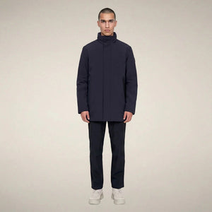 A man wears a dark blue SAVE THE DUCK - BLAISE JACKET IN BLUE BLACK with a high neck and a zippered chest pocket.