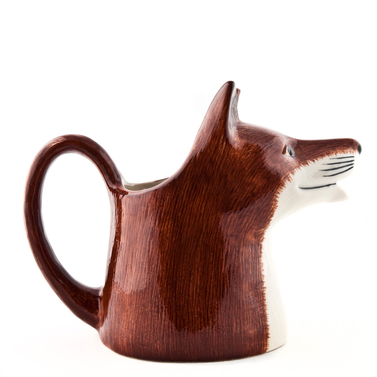 The QUAIL CERAMICS - FOX JUG MEDIUM by QUAIL DESIGNS is a handpainted stoneware jug with reddish-brown and white fur, upright ears, and an open mouth spout. Dishwasher safe and shown on a white background.