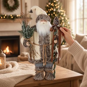 A 27-inch Alpine Santa by Raz Imports wearing a fur-trimmed coat and hat, holding a bundle of pine branches in one hand and a staff topped with a pinecone in the other.