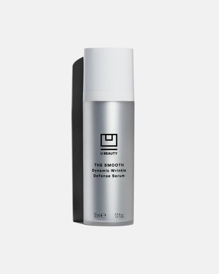 A silver 30ml bottle of U BEAUTY THE SMOOTH DYNAMIC WRINKLE DEFENSE SERUM with white cap and black logo, shown on a light background—an advanced serum designed to visibly reduce fine lines for effective anti-aging care.