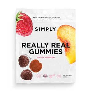A package of SIMPLY GUM - REALLY REAL PEACH RASPBERRY GUMMIES 1.8OZ made from natural ingredients. The white bag features a raspberry and a peach slice at the top, alongside images of the real fruit gummies at the bottom. Label highlights: "Hot Fruit Trio," "Nutrient Boost," "Non-GMO.