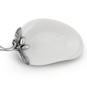 The VAGABOND HOUSE - OLIVE OIL SERVER/SPOON REST is a white, pear-shaped ceramic platter featuring a twig-like ornate metal handle adorned with pewter olives and small fruits. The handle is attached to the narrow end for an elegant touch to this minimalist design.
