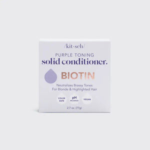 A KITSCH Purple Toning Solid Conditioner Bar sits on its packaging, which states it's formulated with Biotin for blonde and highlighted hair, neutralizing brassiness. The labels affirm it's color safe, pH balanced, and vegan.