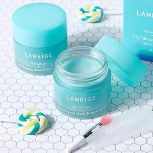 A turquoise jar of LANEIGE LIP SLEEPING MASK MINT CHOCO by KOSMIC KBEAUTY SKINCARE, featuring white text and a matching lid, is displayed against a plain white background.