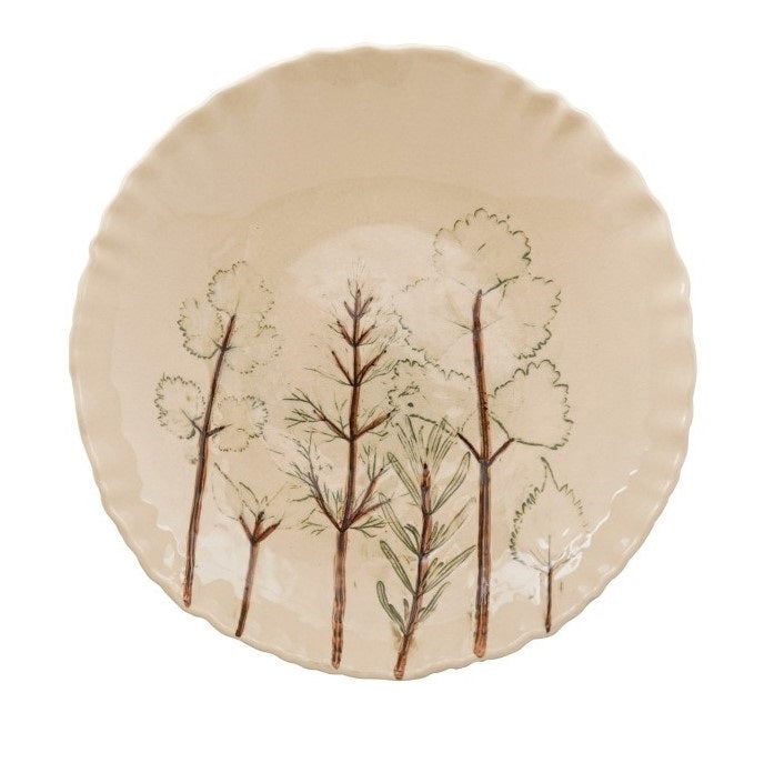 Two views of the CREATIVE COOP HAND-PAINTED ORGANIC SHAPED STONEWARE LOW BOWL WITH BOTANICALS: one features botanical artwork of trees inside, while the other shows its scalloped, organic-shaped edge.