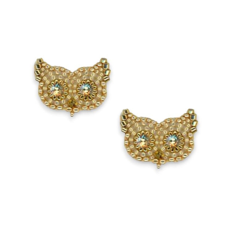 Introducing the MIGUEL ASES - OWL STUD EARRINGS WITH SWAROVSKI CRYSTALS from the renowned brand MIGUEL ASES, INC. These gold-colored owl earrings boast intricate bead patterns and sparkling Swarovski crystal eyes. They are designed to represent tufts of ears at the top and feature handcrafted 14K gold-fill, resulting in a detailed and textured owl design.