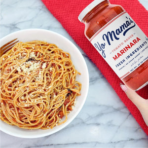 A 25 oz (708g) glass jar of YO MAMA'S - ORIGINAL MARINARA SAUCE by YO MAMA'S FOODS with a white label displaying the brand, product details, and "no sugar added." Keto certified sauce is visible through the jar.