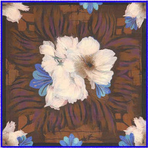 A woman stands indoors near a window, smiling at the camera. She is wearing a cream sweater and blue jeans, accessorized with the FRANCO FERRARI - FLORAL WOOL SCARF 115X115 by FRANCO FERRARI, which features artistic brown floral patterns.