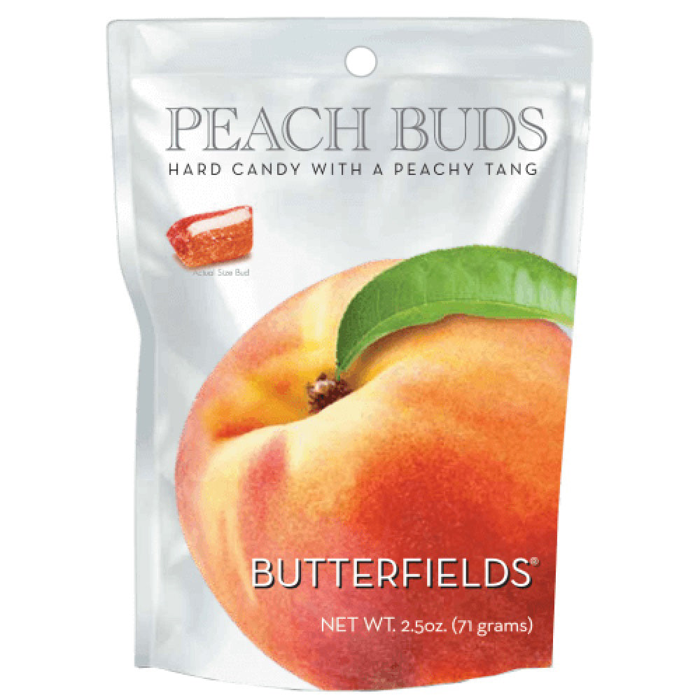 A round tin with a lid featuring a watercolor illustration of a peach. The tin, labeled &quot;BUTTERFIELDS - PEACH BUDS,&quot; displays two halves of a peach, one with a pit. Treat yourself to this delightful hard candy, proudly made in the United States by Butterfields.