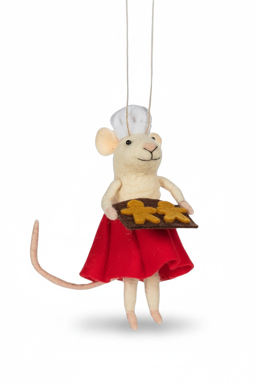 An ABBOTT PASTRY CHEF MOUSE felt ornament wearing a red skirt and holding a cookie tray, hanging on a Christmas tree.