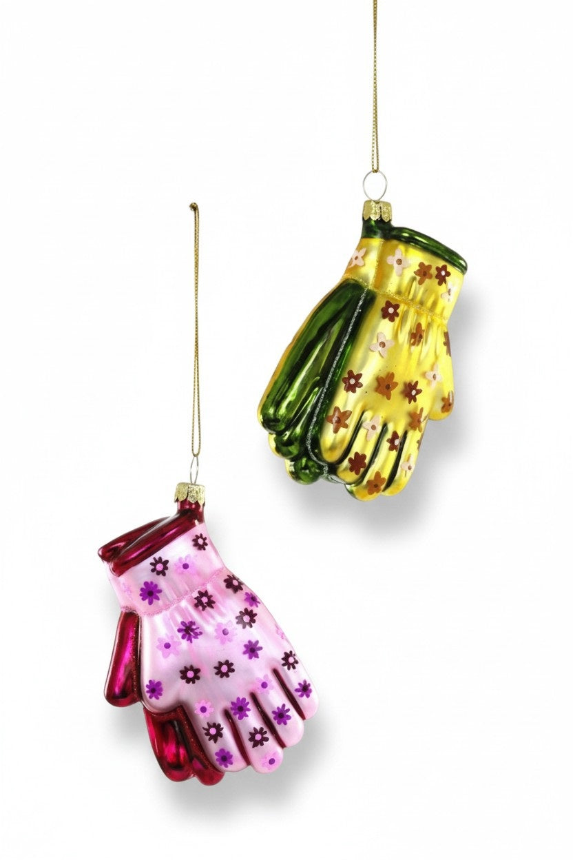 Two GARDENING GLOVES ORNAMENT glass decorations, one pink with purple flowers and one yellow with orange flowers, hanging from gold strings.