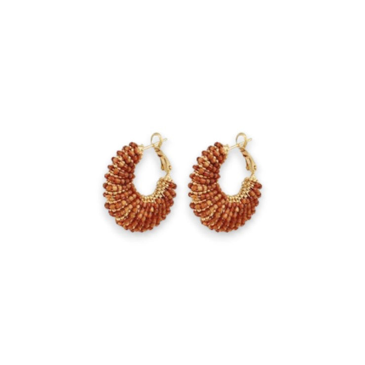 A pair of GAS BIJOUX - IZZIA EARRINGS, small and crescent-shaped with a gold-plated finish, embellished with reddish-brown beads on a gold base. These handmade earrings from the GAS BIJOUX brand feature a textured and layered look, thanks to the densely arranged beads. They are equipped with gold hooks for easy wearing against a plain white background.