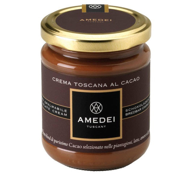 A jar of AMEDEI - Crema Toscana Nocciola with Cacao by Atalanta Corporation is shown. It has a golden lid and a label featuring various text, including "AMEDEI Tuscany" and mentions of "latte cream" and "schokoladen." Infused with Tonda Gentile Trilobata Hazelnuts, the dark brown and gold label highlights its luxurious appearance and intense chocolate flavor.