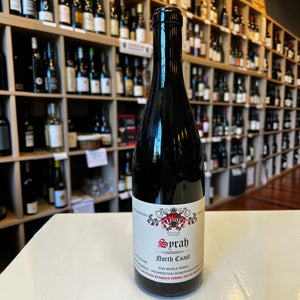 A bottle of PAX ‘NORTH COAST’ SYRAH 2023 from WINE: KELLOGG SELECTIONS, featuring a cream label with red and black text and a decorative crest, stands against a plain white background—an elegant tribute to cool-climate Syrah crafted in the spirit of esteemed winemakers such as Pax Mahle.