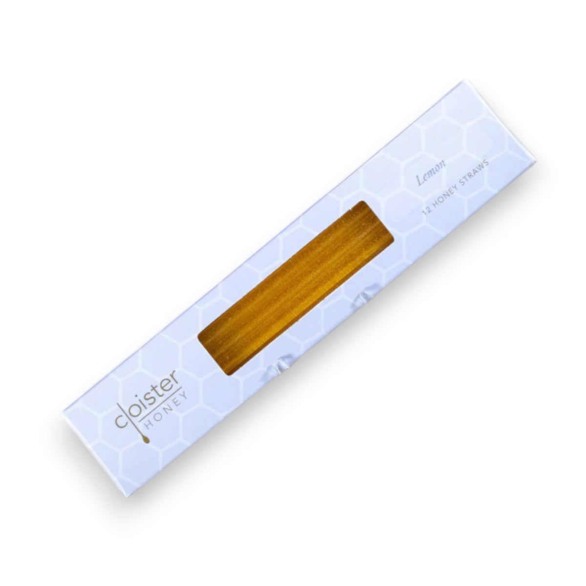A white box from Cloister Honey, featuring a hexagonal pattern, displays Lemon Honey Straws made from natural honey, visible through a rectangular window.