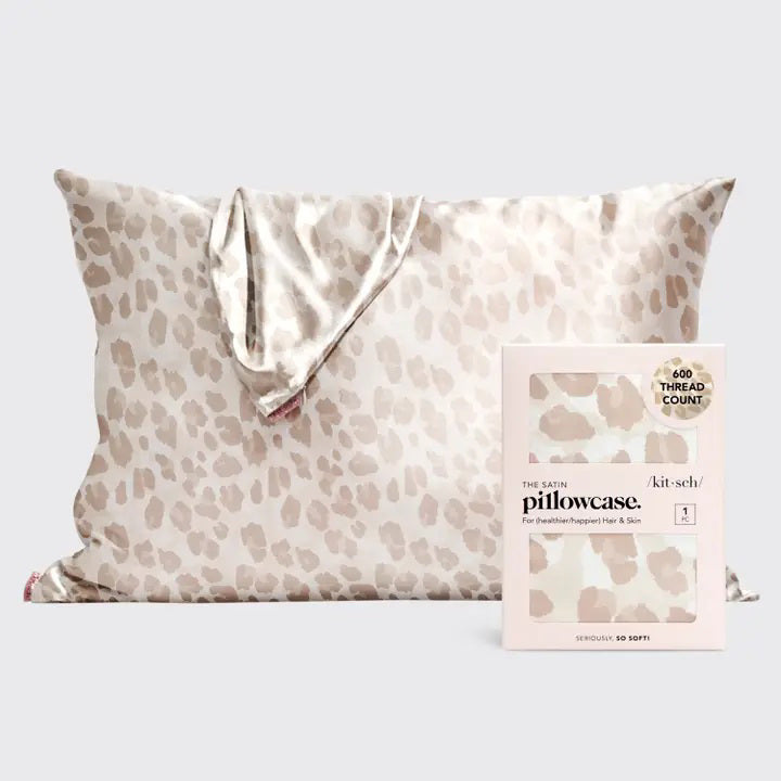 A beige leopard print KITSCH - SATIN PILLOWCASE by KITSCH is displayed with packaging emphasizing its frizz-free, 100% premium satin finish and 600 thread count, ideal for hair and skin benefits.