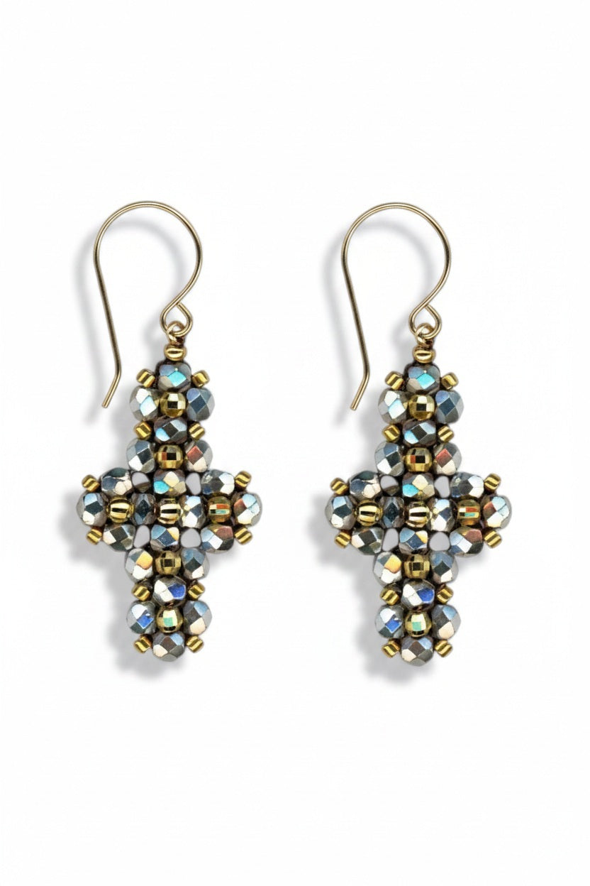 The MIGUEL ASES - PYRITE MIYUKI CROSS EARRINGS by MIGUEL ASES, INC. feature handcrafted dangling cross shapes with metallic and iridescent pyrite beads, finished with gold hooks—a stunning jewelry piece.