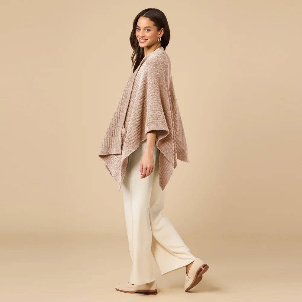 A woman wearing a black SOFTIES - SOLID RIB MARSHMALLOW SHAWL over a grey top and white trousers.