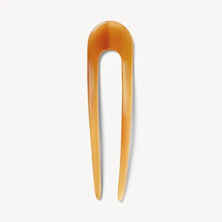 A smooth, black MACHETE - FRENCH HAIR PIN with two prongs, crafted from Italian acetate by MACHETE, rests on a plain white surface.