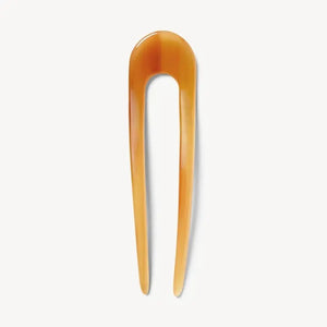 A smooth, black MACHETE - FRENCH HAIR PIN with two prongs, crafted from Italian acetate by MACHETE, rests on a plain white surface.