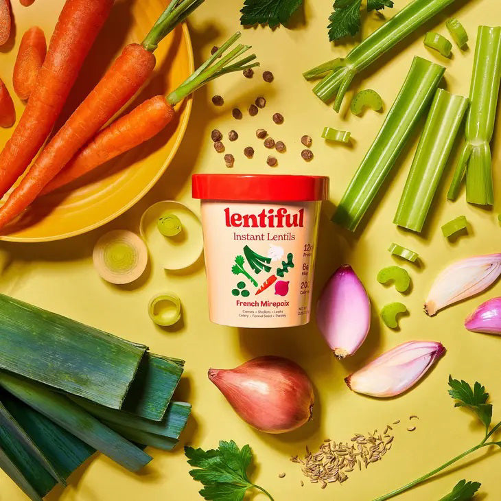 A container of LENTIFUL - FRENCH MIREPOIX INSTANT LENTILS by LENTIFUL, with a red lid and vegetable images. Each serving provides 12g protein, 6g fiber, and 200 calories. The lentils feature a Mirepoix flavor with French-style seasoning.
