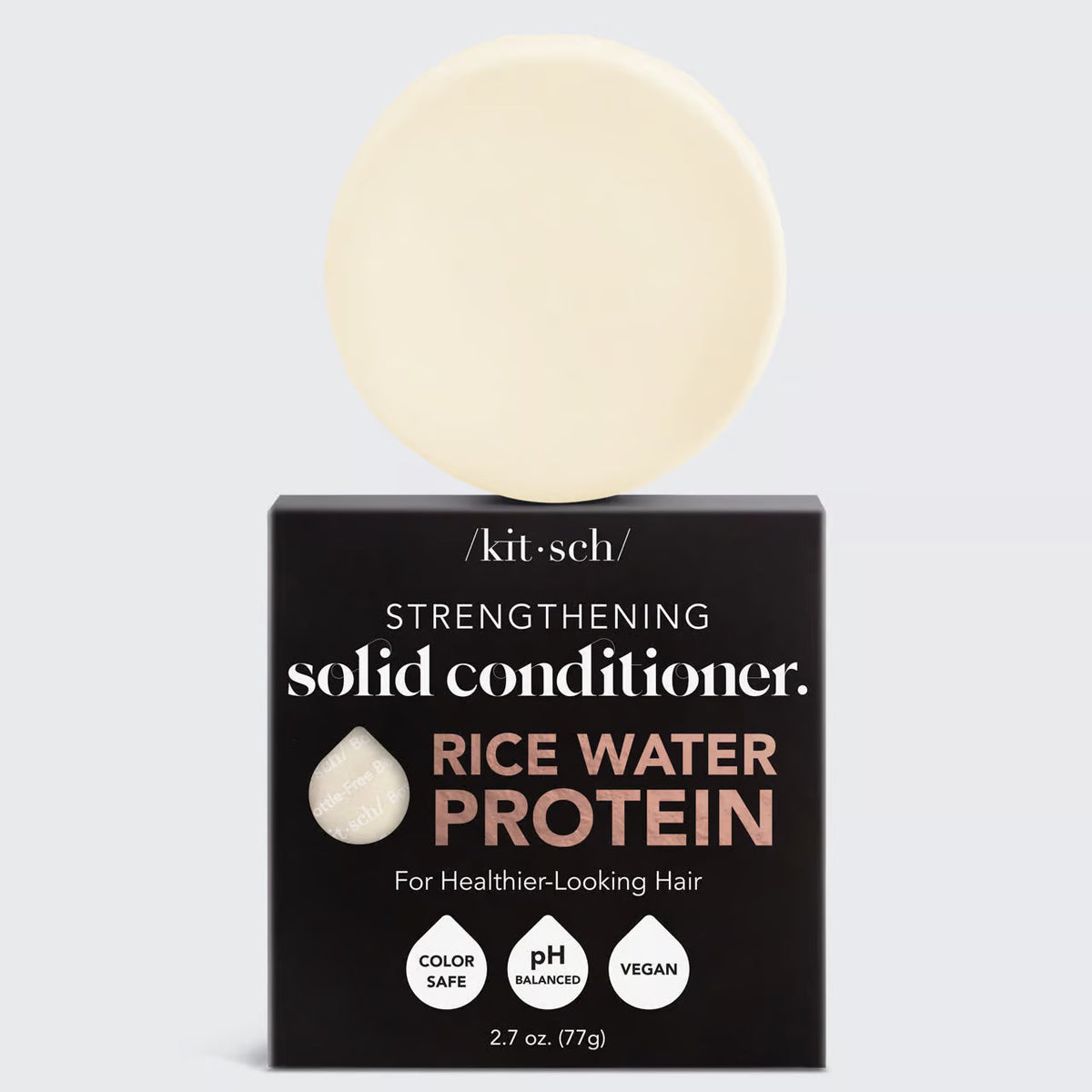 A round, off-white solid conditioner bar rests on its black and white packaging labeled "KITSCH - RICE WATER PROTEIN CONDITIONER BAR FOR HAIR GROWTH," promoting benefits for damaged hair repair. The product is color safe, pH balanced, and vegan.