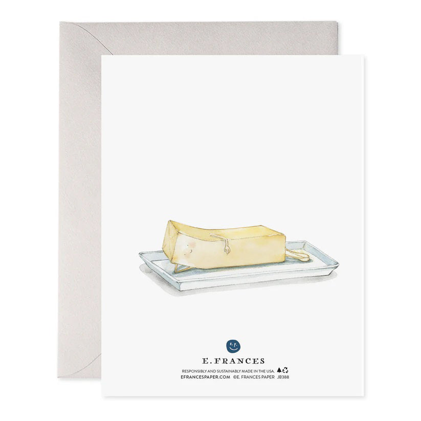 The E. Frances Paper "More Than Butter" greeting card features a whimsical watercolor of a butter stick with tiny arms and legs. "LOVE YOU MORE THAN" text adorns the top, and it comes with a light gray envelope, proudly made in the USA.