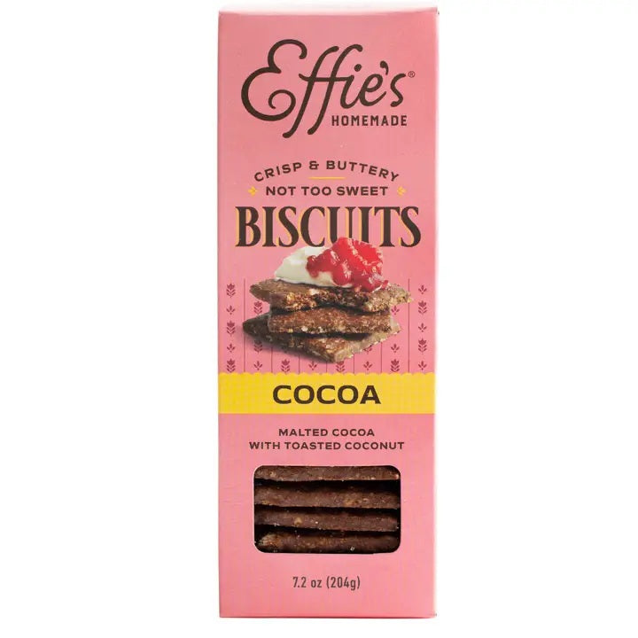 A pink box of EFFIES - COCOA BISCUIT from EFFIES HOMEMADE, labeled “Crisp & Buttery, Not Too Sweet.” The packaging displays chocolate biscuits with raspberries and includes a window to showcase the rich malted cocoa biscuits inside.