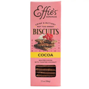 A pink box of EFFIES - COCOA BISCUIT from EFFIES HOMEMADE, labeled “Crisp & Buttery, Not Too Sweet.” The packaging displays chocolate biscuits with raspberries and includes a window to showcase the rich malted cocoa biscuits inside.