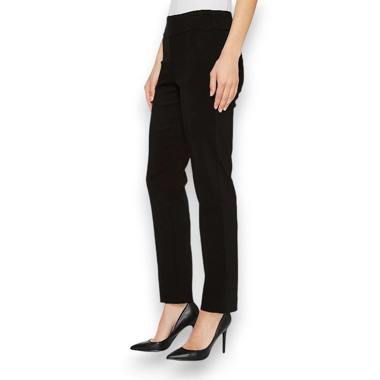 A person is wearing KRAZY LARRY, INC&#39;s PULL ON ANKLE PANT in a slim fit beige straight-leg style and black high-heeled shoes against a white background. The outfit is completed with a sleeveless black top that reveals part of the arms and torso.