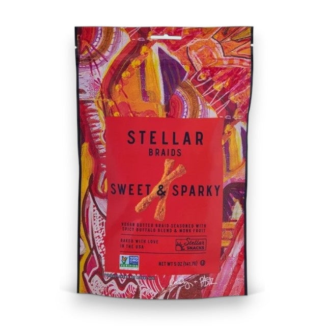 A vibrant bag of STELLAR SNACKS - SWEET &amp; SPARKY PRETZEL BRAIDS, showcasing bold red and orange abstract artwork, flavorful buffalo-inspired seasoning, and clear product information on the front—the ideal pick for those who love spicy snacks.