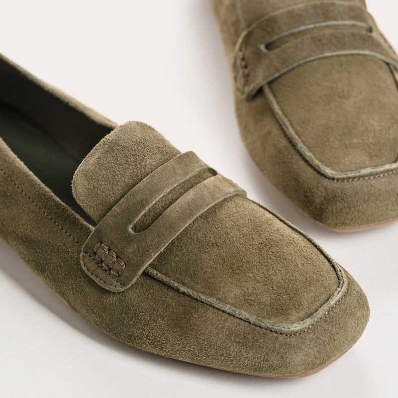 REQINS - HEMA suede loafers in olive feature a classic silhouette, flat sole, decorative upper strap, and comfortable leather insole, shown in side profile against a plain light background.