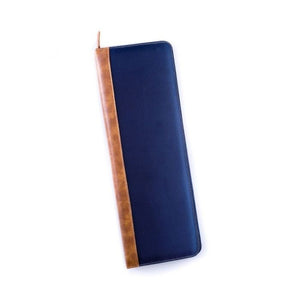 The BEYBERK INTERNATIONAL TRAVEL TIE CASE, crafted from durable ballistic nylon in navy and brown, is open to display organized compartments for a tie, tie bar, and collar stays. The closed case rests neatly beside it.