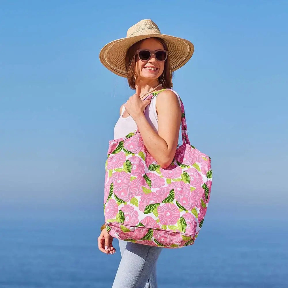 The ROCKFLOWERPAPER POPPY PAPAVER BUCKET BAG is a spacious cotton canvas tote with large pink flowers and green leaves on white. Featuring two handles, this stylish bag by ROCKFLOWERPAPER is perfect for everyday shopping or casual use.