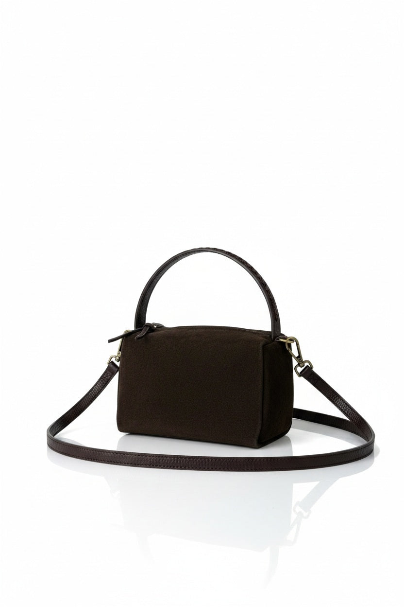 LE BORSETTE dark brown suede crossbody handbag with a top handle, leather trim, and an adjustable shoulder strap.