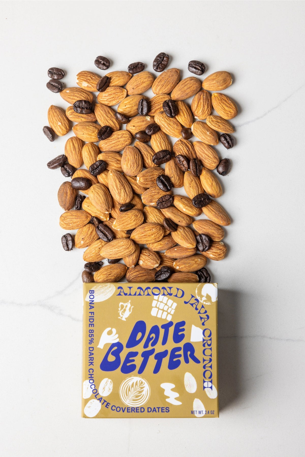 Three DATE BETTER - ALMOND JAVA CRUNCH COVERED DATES, by DATE BETTER SNACKS, arranged on a dark slate surface offer a deliciously healthy candy alternative.