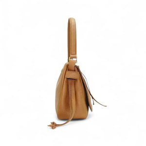 Side view of the OLIVEVE Remi Medium Slouchy Shoulder Bag in Miel Buffalo Cowhide, showcasing its luxurious Italian buffalo cowhide leather, single crossbody strap, visible drawstring, and textured surface against a plain white background.