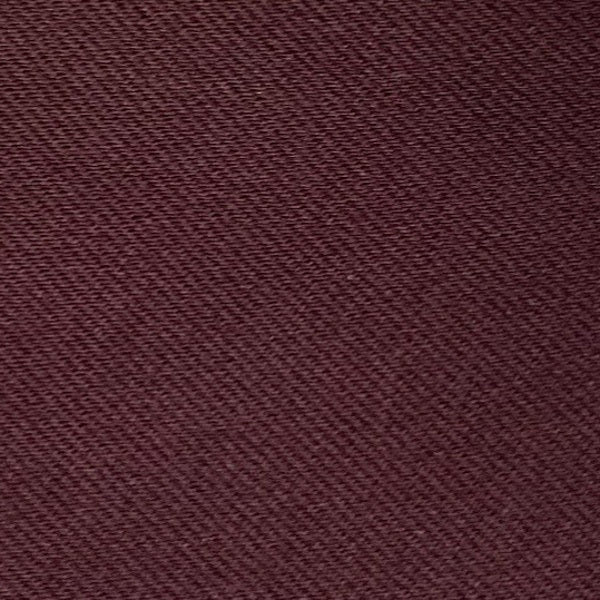 A woman with long dark hair in a low ponytail stands in profile against a plain light background, wearing the MEIMEIJ MESH LAYERING TOP by MEIMEIJ in red and a black skirt for a minimalist Italian fashion look.