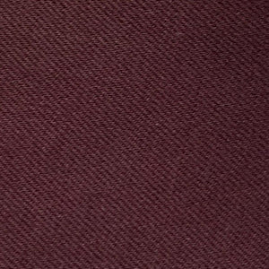 A woman with long dark hair in a low ponytail stands in profile against a plain light background, wearing the MEIMEIJ MESH LAYERING TOP by MEIMEIJ in red and a black skirt for a minimalist Italian fashion look.