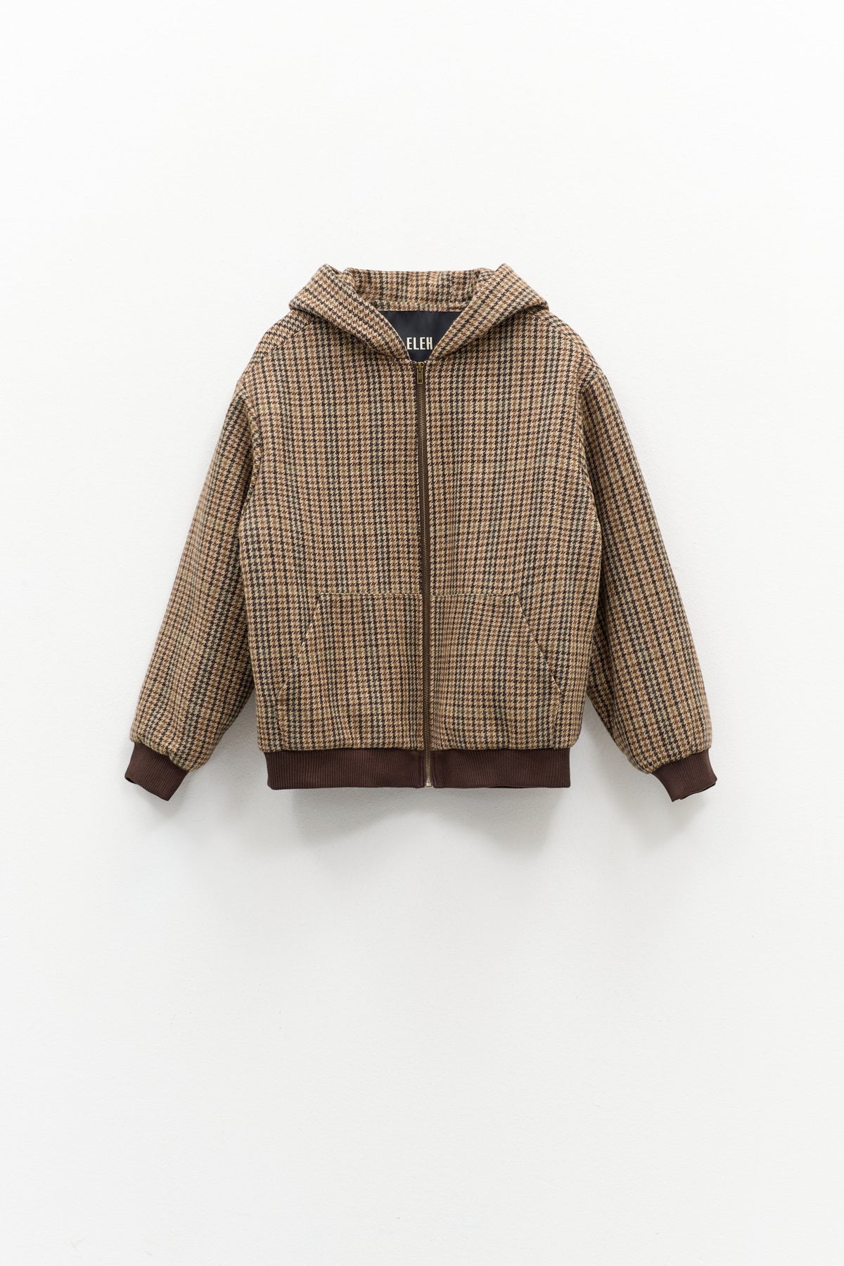 The ELEH - FIRENZE HOODED BOMBER by ELEH is a brown jacket with a classic check pattern, zip-up front, long sleeves, and ribbed cuffs and hem, displayed against a plain white background.