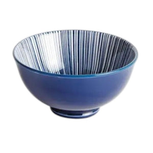 The NAPA HOME AND GARDEN - BLUE AND WHITE STRIA BOWL features a smooth blue exterior and an interior lined with thin vertical blue and white stripes for a modern look.