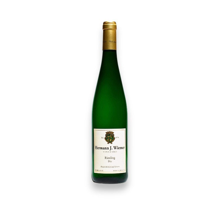 A green wine bottle with a gold foil top, labeled "HERMANN J WIEMER RIESLING 2023" from WINE: KELLOGG SELECTIONS, hints at citrus notes and represents the Finger Lakes region, standing upright on a white background.