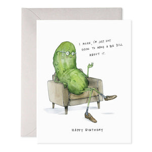 The E. FRANCES PAPER - BIG DILL GREETING CARD showcases a cartoon pickle with glasses, sitting cross-legged in an armchair, with the text: "I mean, I’m just not going to make a big dill about it. Happy Birthday." It's a charming whimsical card for any collection!.